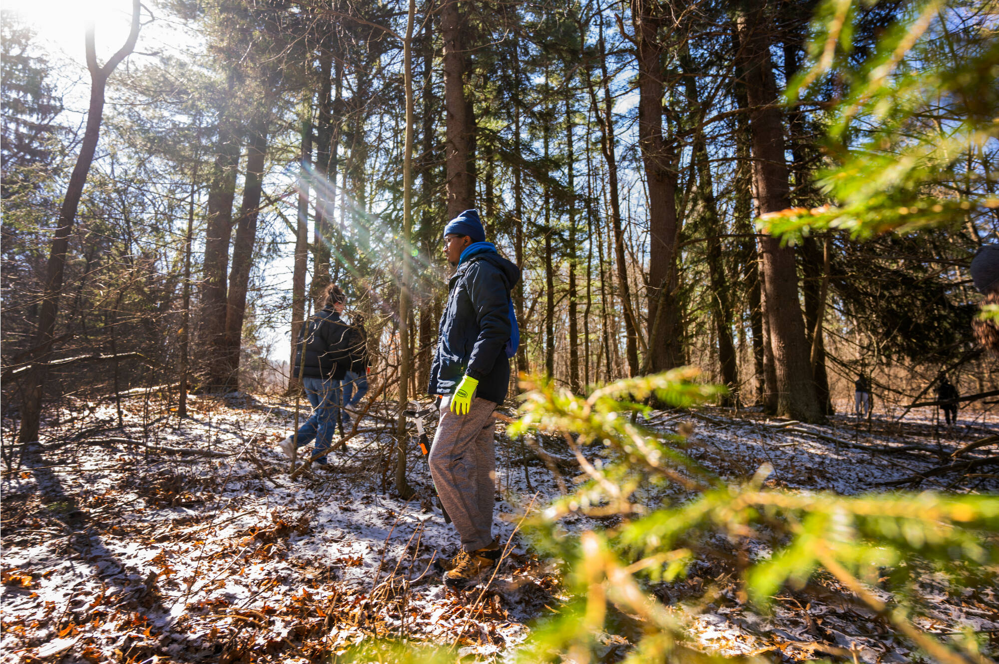 student cleaning in forest